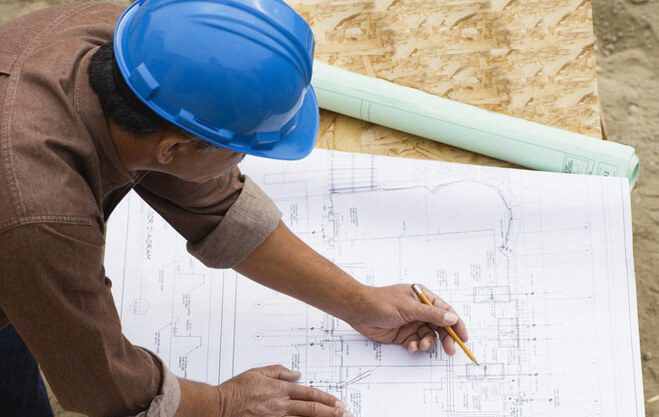 Contractor Working on Building Plans --- Image by © Royalty-Free/Corbis